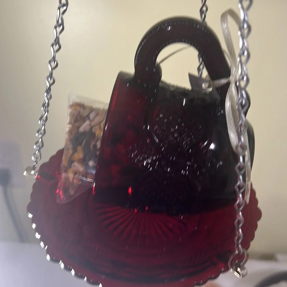 Cup and saucer bird feeder made of vintage glassware.